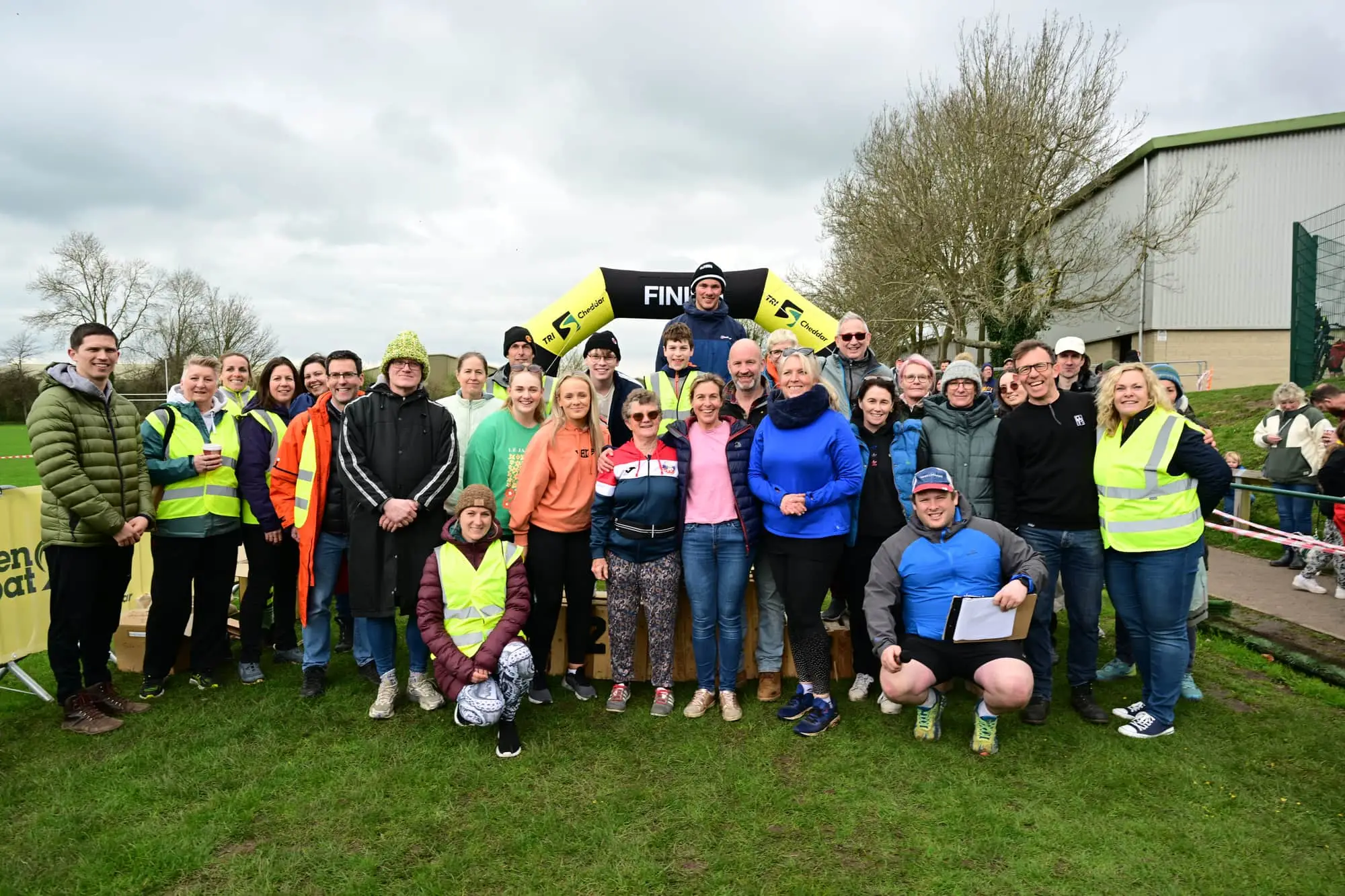 Group of smiling TriCheddar volunteer marshals in hi-vis at Kings Fitness & Leisure