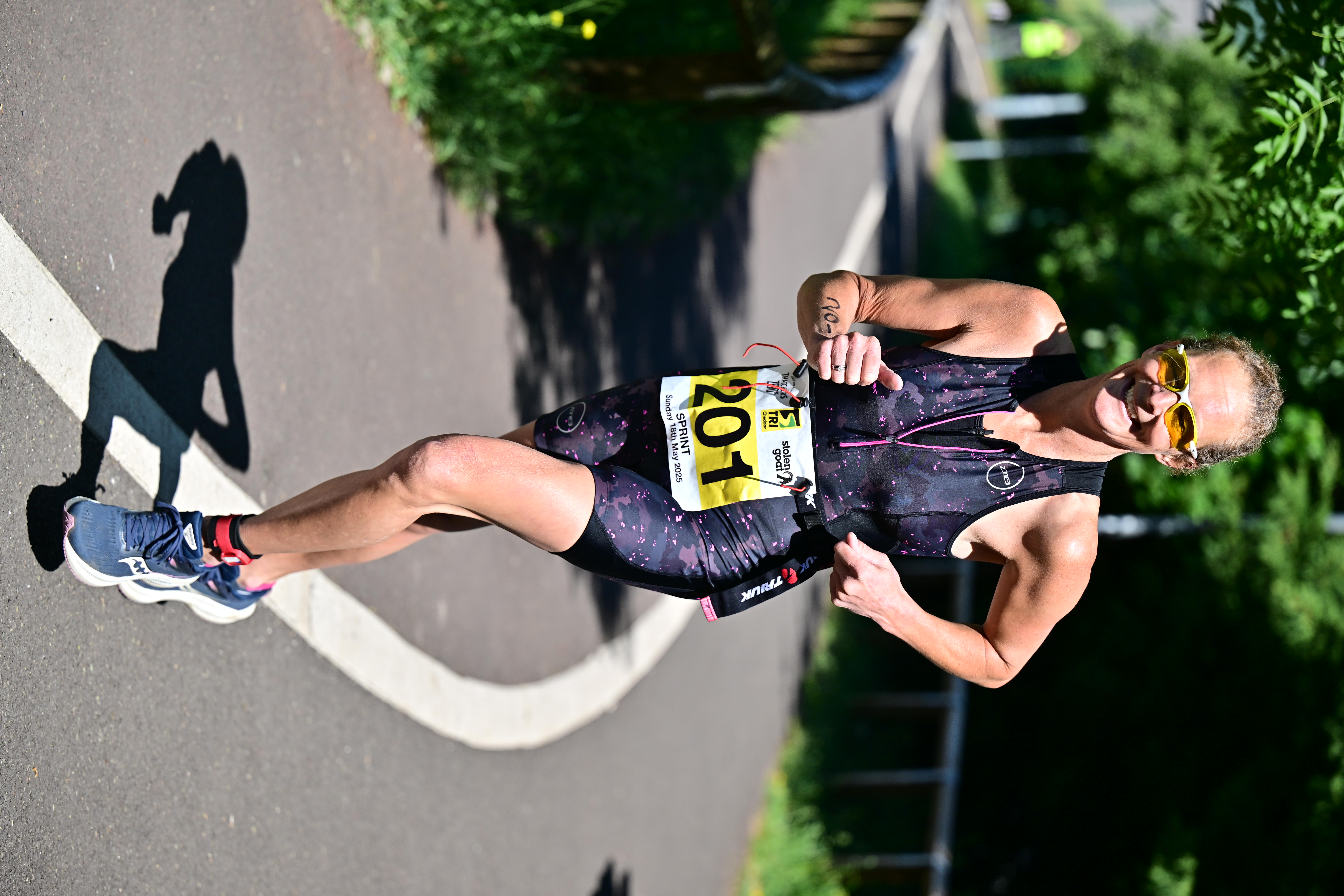 Runner smiling on the Strawberry Line during a TriCheddar race