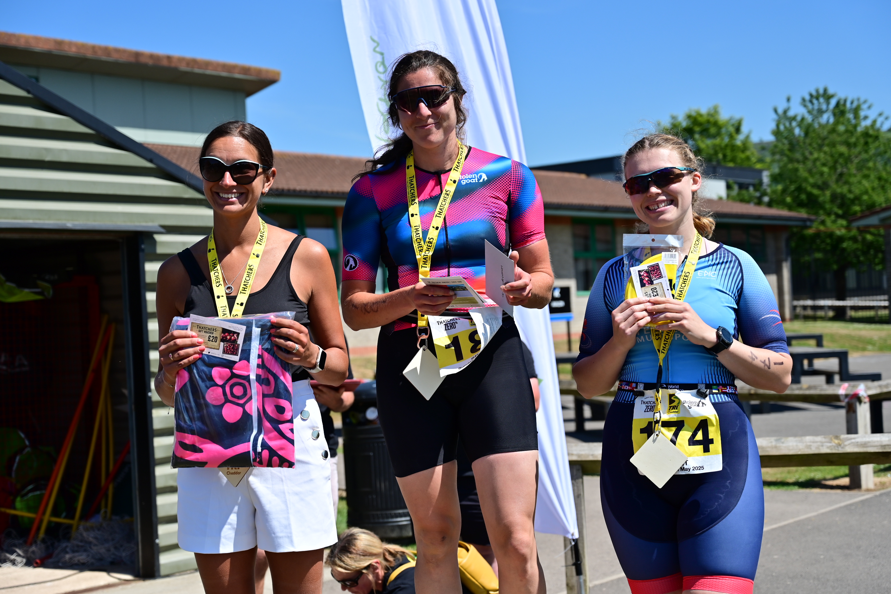 TriCheddar triathlon podium finishers holding their medals in Cheddar Gorge